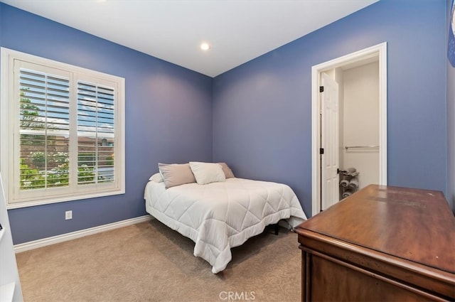 carpeted bedroom featuring baseboards and recessed lighting