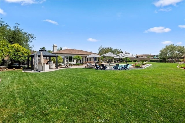 view of green lawn featuring a gazebo, a patio, and an outdoor pool