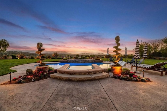 swimming pool with a patio area and a lawn