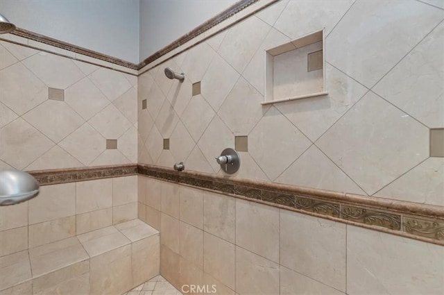 bathroom with tiled shower