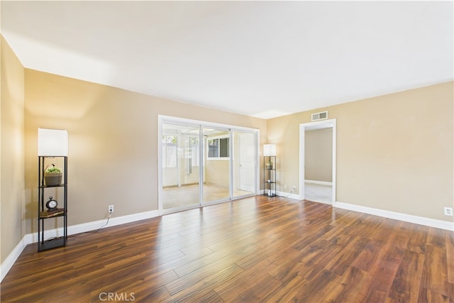 spare room with wood finished floors and baseboards