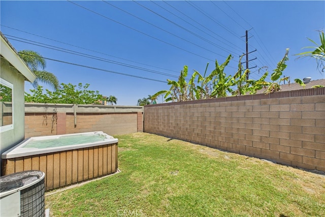 view of yard with a hot tub and cooling unit