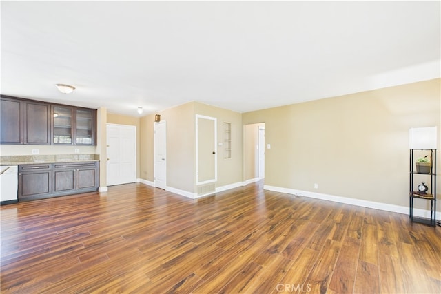 unfurnished living room with dark wood finished floors and baseboards