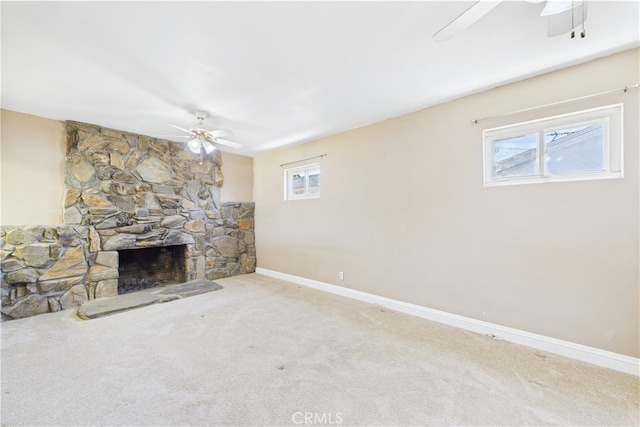 unfurnished living room featuring a ceiling fan, carpet, and healthy amount of natural light