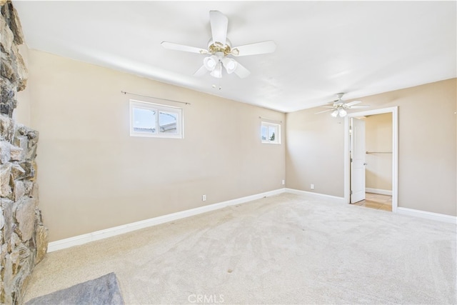 unfurnished bedroom featuring carpet, baseboards, and ceiling fan