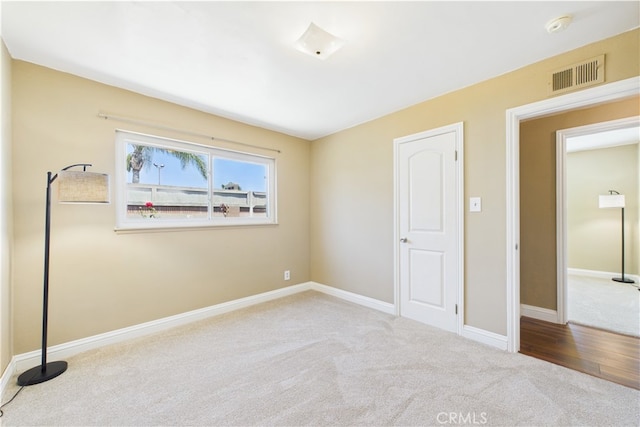 unfurnished bedroom with carpet flooring and baseboards