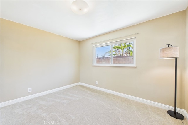 empty room with carpet and baseboards