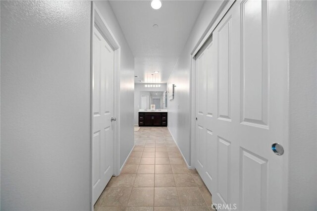 3344 Pokeroot Ln, San Bernardino, CA 92407 - hallway with light tile patterned flooring and baseboards