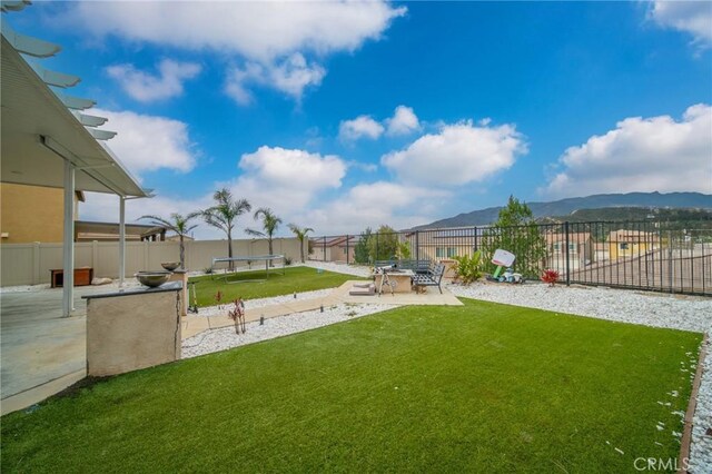 3344 Pokeroot Ln, San Bernardino, CA 92407 - view of yard with a patio, a mountain view, and a trampoline