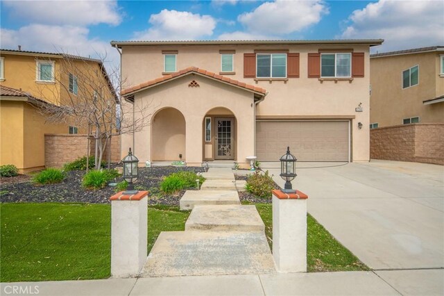 3344 Pokeroot Ln, San Bernardino, CA 92407 - mediterranean / spanish-style home featuring an attached garage, stucco siding, concrete driveway, and a tiled roof