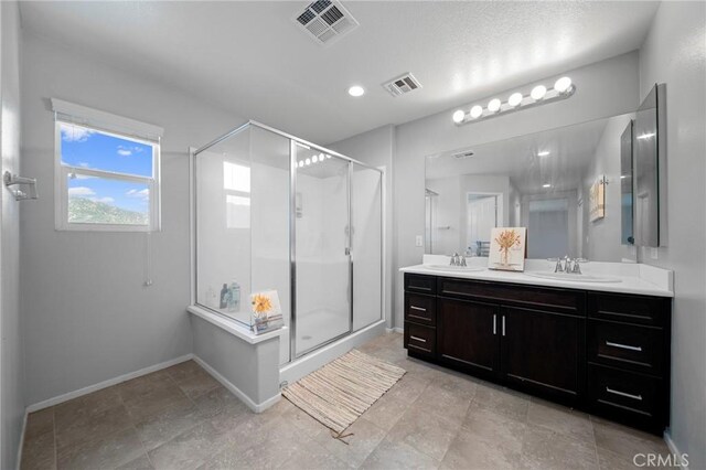 3344 Pokeroot Ln, San Bernardino, CA 92407 - bathroom featuring a stall shower, double vanity, and baseboards