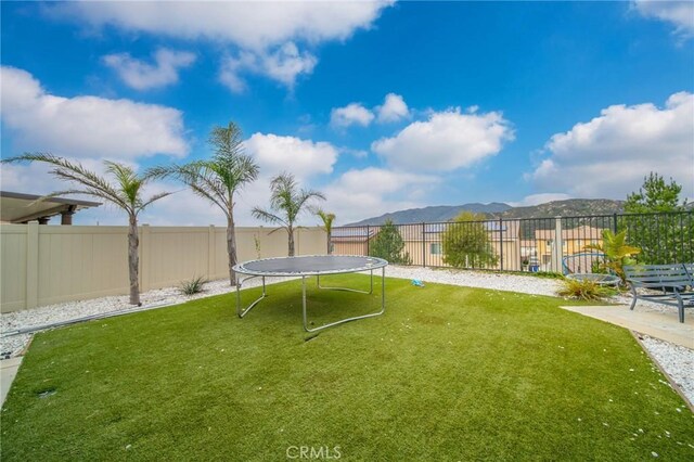 3344 Pokeroot Ln, San Bernardino, CA 92407 - view of yard featuring a trampoline and a mountain view
