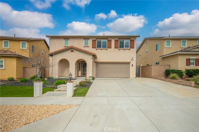 3344 Pokeroot Ln, San Bernardino, CA 92407 - mediterranean / spanish-style house featuring an attached garage, stucco siding, and concrete driveway