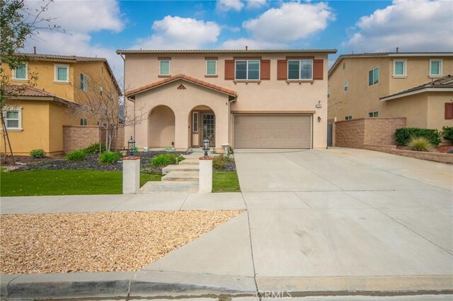 3344 Pokeroot Ln, San Bernardino, CA 92407 - mediterranean / spanish-style house featuring a garage, stucco siding, concrete driveway, and a tiled roof