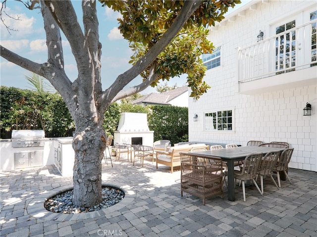 6443 W 81st St, Los Angeles, CA 90045 - view of patio featuring exterior fireplace, outdoor dining area, and a balcony