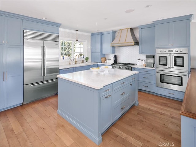 6443 W 81st St, Los Angeles, CA 90045 - kitchen featuring appliances with stainless steel finishes, custom range hood, a sink, light countertops, and light wood-style flooring