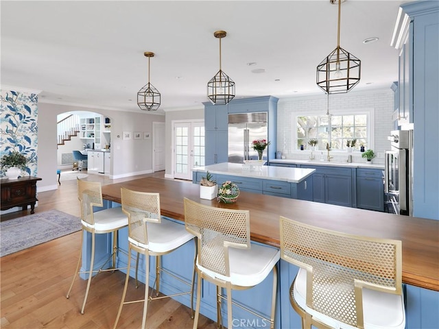 6443 W 81st St, Los Angeles, CA 90045 - kitchen featuring built in fridge, blue cabinets, oven, light wood finished floors, and light countertops