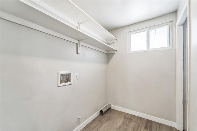laundry room featuring hookup for a washing machine, baseboards, and light wood finished floors