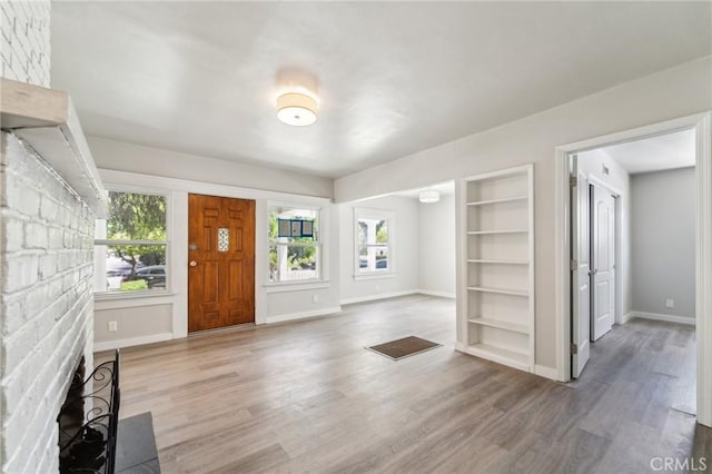 foyer featuring wood finished floors and baseboards