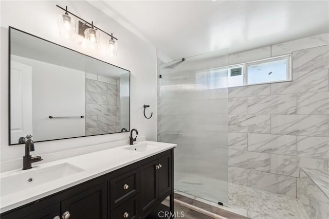 bathroom with a walk in shower and double vanity