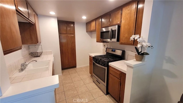 2364 S Cutty Way Unit 3, Anaheim, CA 92802 - kitchen featuring stainless steel appliances, light tile patterned floors, recessed lighting, and tile countertops