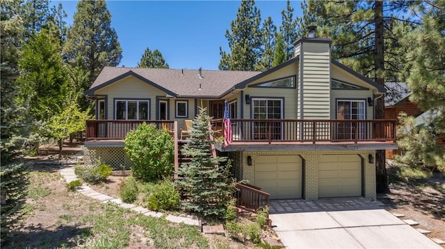 919 S Waldstrasse Way, Big Bear Lake, CA 92314 - view of front of home with a chimney, driveway, an attached garage, brick siding, and a wooden deck