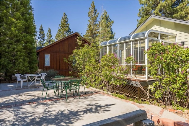 919 S Waldstrasse Way, Big Bear Lake, CA 92314 - view of patio with outdoor dining area and a sunroom