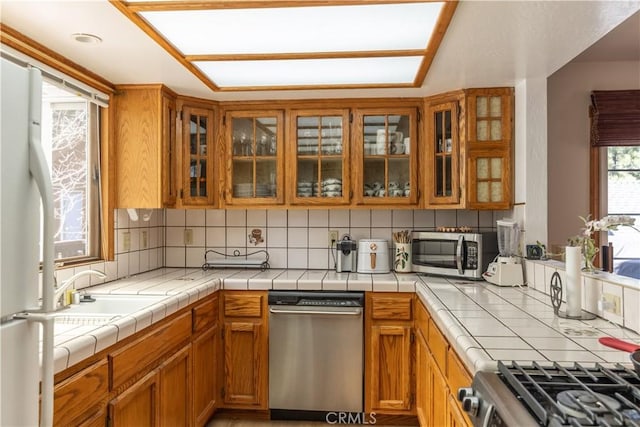 919 S Waldstrasse Way, Big Bear Lake, CA 92314 - kitchen with appliances with stainless steel finishes, tasteful backsplash, and brown cabinets