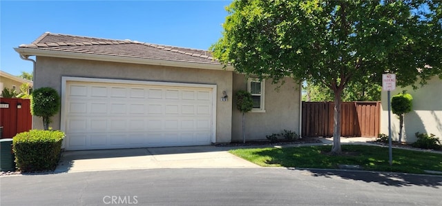 8281 Triplett Ln, Hemet, CA 92545 - view of front of house with concrete driveway, stucco siding, a garage, a tile roof, and central AC unit
