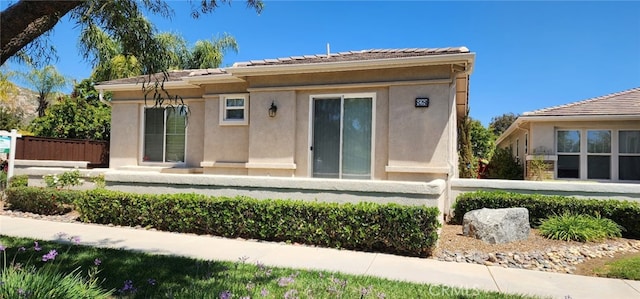8281 Triplett Ln, Hemet, CA 92545 - back of property with a fenced front yard, stucco siding, and a tile roof