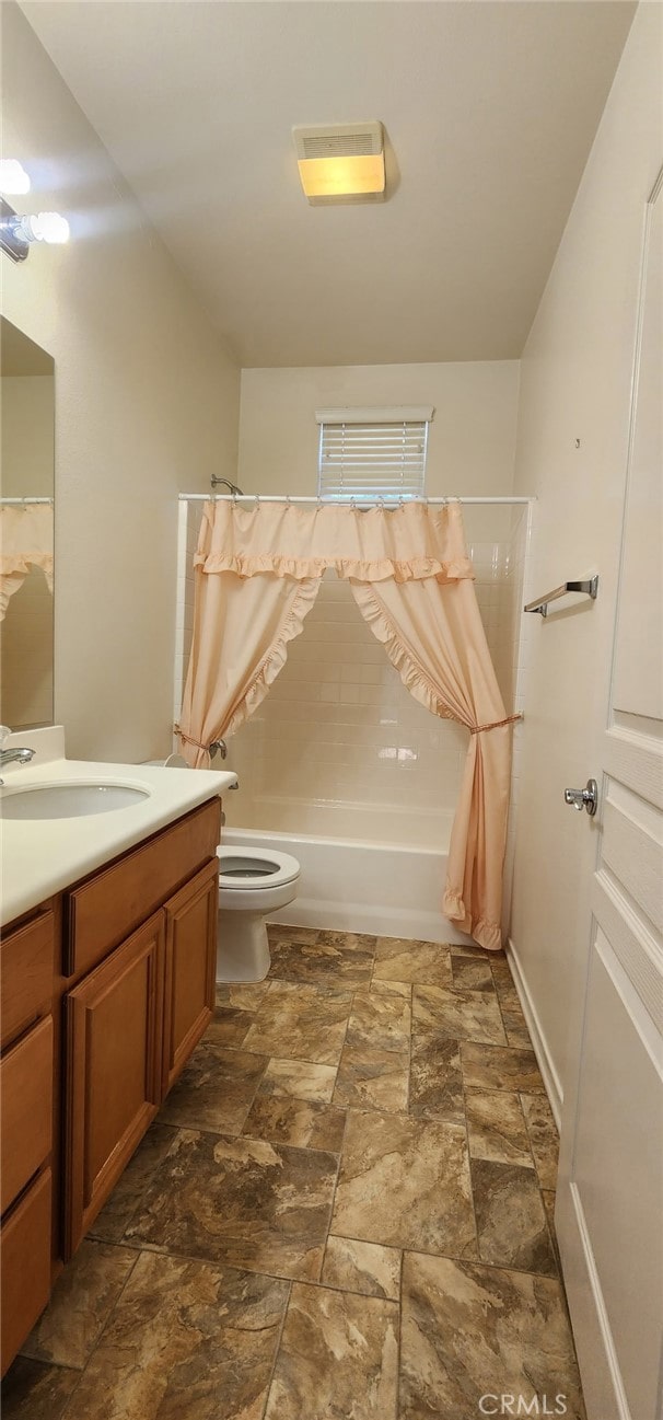 8281 Triplett Ln, Hemet, CA 92545 - full bathroom with vanity, stone finish floors, shower / bath combo, and toilet