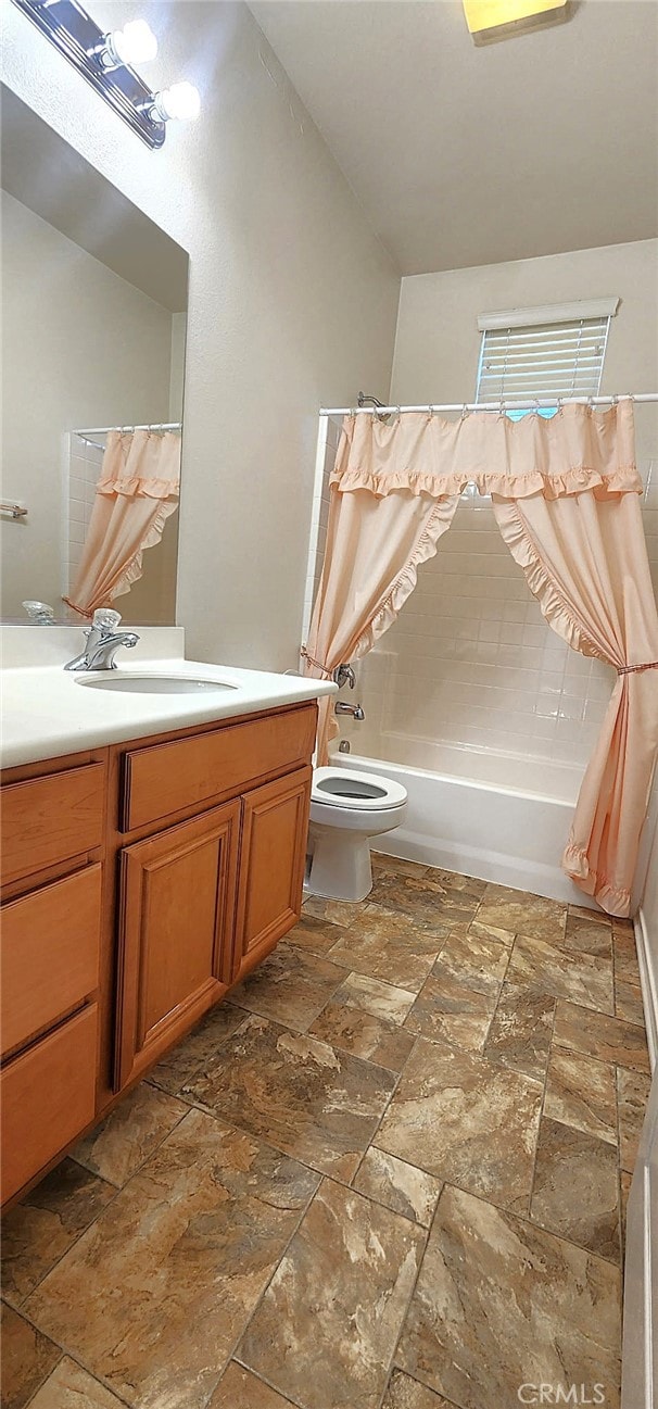 8281 Triplett Ln, Hemet, CA 92545 - bathroom with stone tile floors, shower / tub combo with curtain, vanity, and toilet