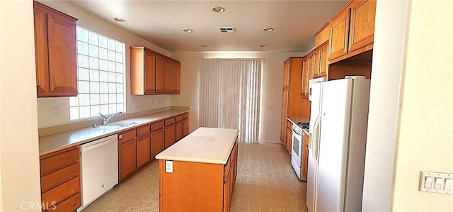 8281 Triplett Ln, Hemet, CA 92545 - kitchen featuring white appliances, a kitchen island, a sink, brown cabinetry, and recessed lighting