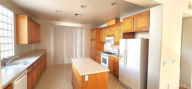 8281 Triplett Ln, Hemet, CA 92545 - kitchen featuring white appliances, a sink, light flooring, a kitchen island, and recessed lighting