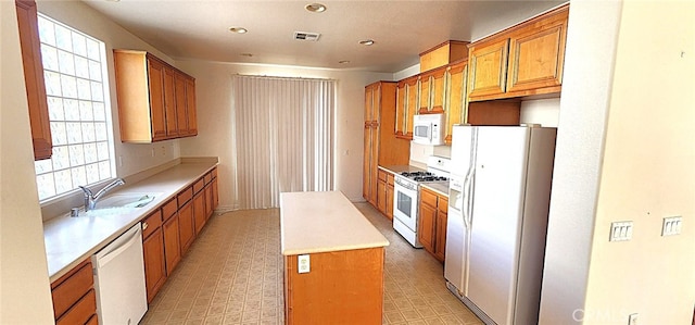 8281 Triplett Ln, Hemet, CA 92545 - kitchen with white appliances, a sink, light flooring, brown cabinetry, and recessed lighting