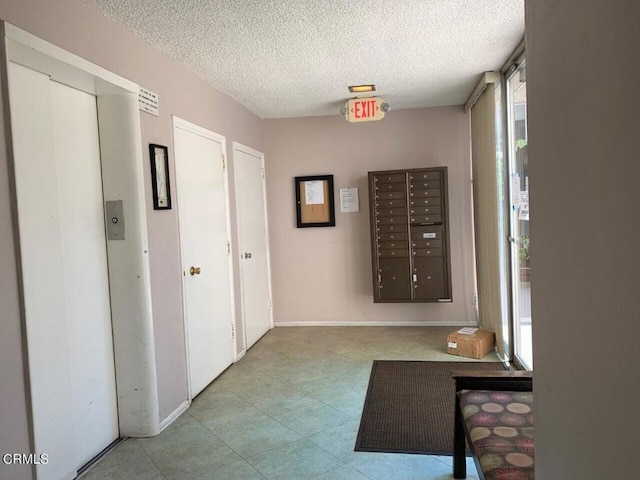 1810 Ramona Ave Unit 15, South Pasadena, CA 91030 - corridor with a textured ceiling, mail area, elevator, and tile patterned flooring