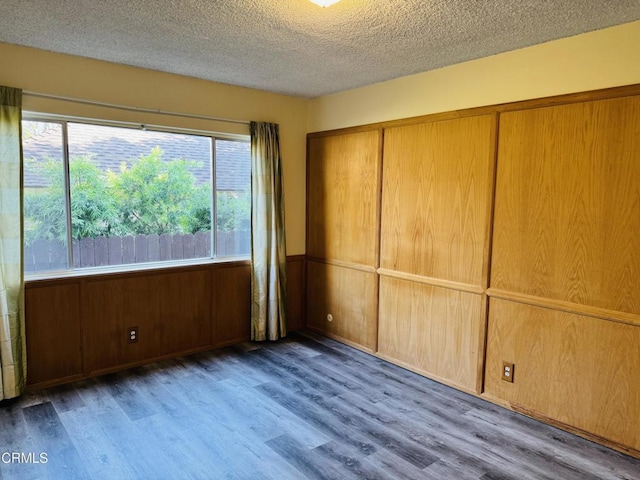 1810 Ramona Ave Unit 15, South Pasadena, CA 91030 - unfurnished bedroom featuring a textured ceiling, wood finished floors, and wood walls