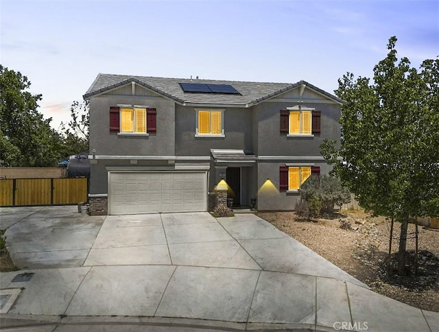 1021 Cambridge Ct, Lancaster, CA 93535 - traditional home featuring concrete driveway, stucco siding, solar panels, a garage, and a tiled roof