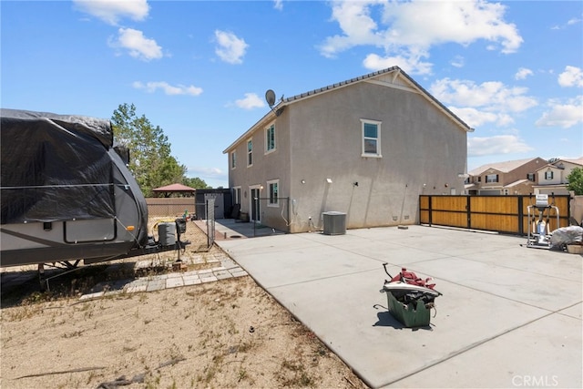 1021 Cambridge Ct, Lancaster, CA 93535 - rear view of property featuring a patio, a fenced backyard, stucco siding, and cooling unit