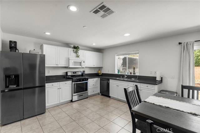 1021 Cambridge Ct, Lancaster, CA 93535 - kitchen with appliances with stainless steel finishes, a sink, dark countertops, white cabinetry, and recessed lighting