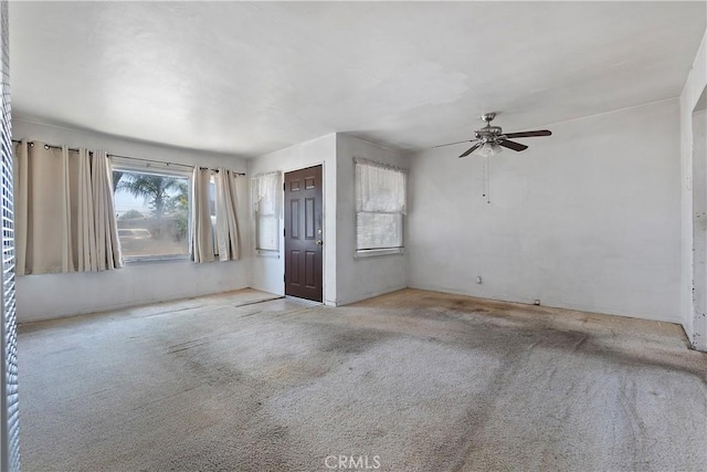 carpeted empty room featuring ceiling fan