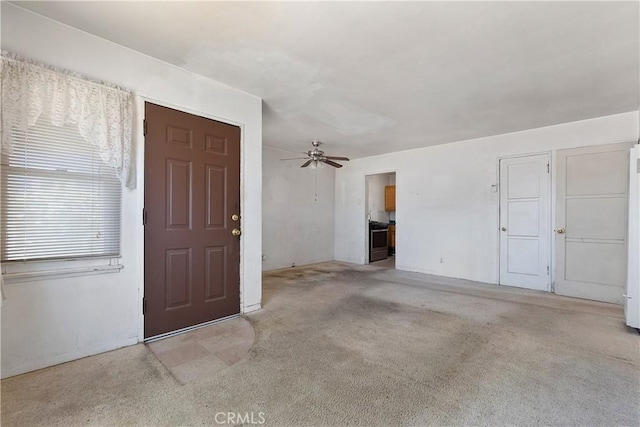foyer with ceiling fan and light colored carpet