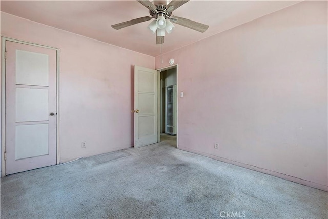 spare room featuring carpet floors and a ceiling fan