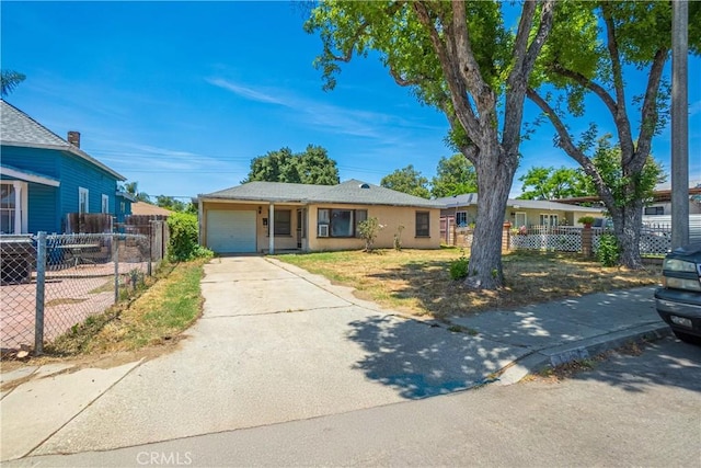 view of front of house featuring an attached garage, driveway, and stucco siding