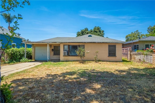 view of front of house featuring stucco siding, a garage, and driveway