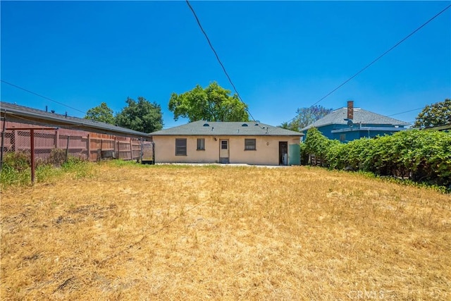 back of property featuring stucco siding