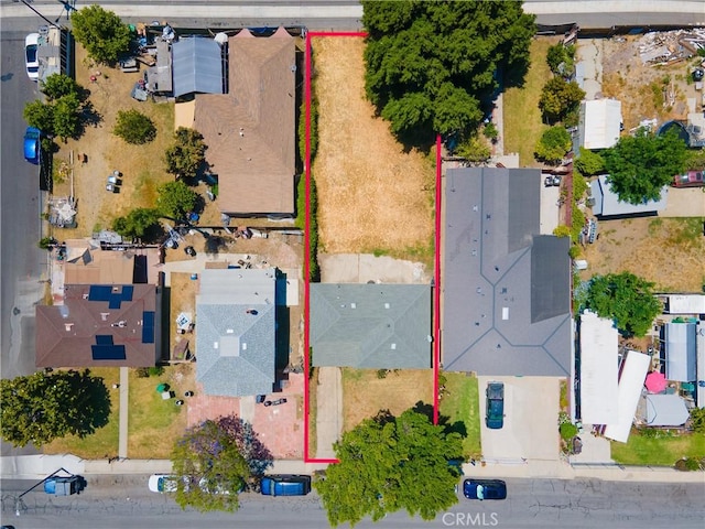 aerial view of property and surrounding area featuring property parcel outlined