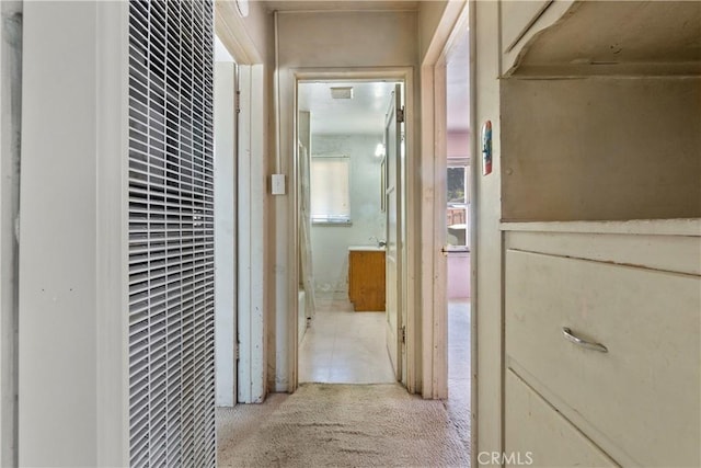 corridor with a heating unit and light carpet
