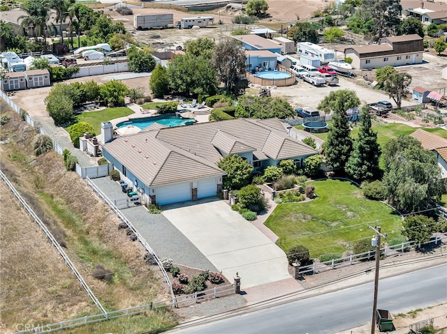 aerial view of property and surrounding area featuring a pool