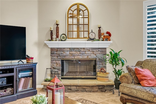living room with a fireplace and stone finish floors